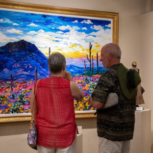 elderly man and woman looking at painting