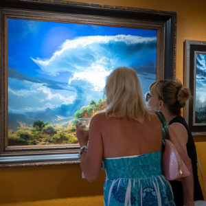 2 women looking at landscape painting